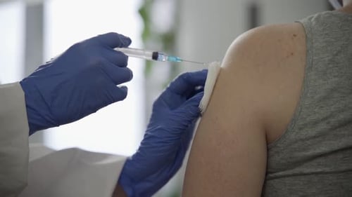 Adult Receives Injection in Upper Arm
