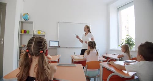 Teacher Instructing Children in Elementary School Classroom