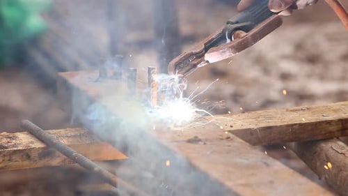 worker use electric welding for cutting hole and drill metal