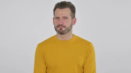 Man in Yellow Shirt Tilting Head