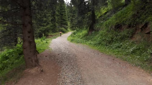 Man Ride Bicycle on the Mountain Road Aerial Shot