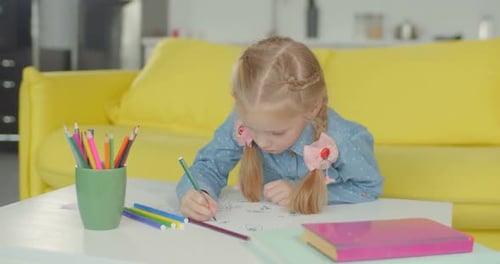 Young Girl Drawing at Home on Paper