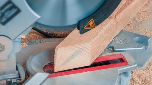 Carpenter Using Circular Saw for Cutting Wooden Boards