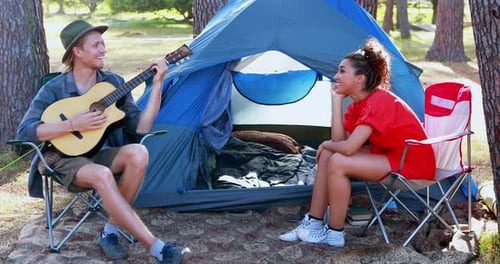 Couple Camping in Nature With Guitar Music