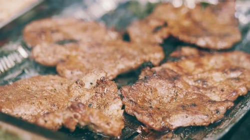 Close-up of sizzling grilled meat on a barbecue