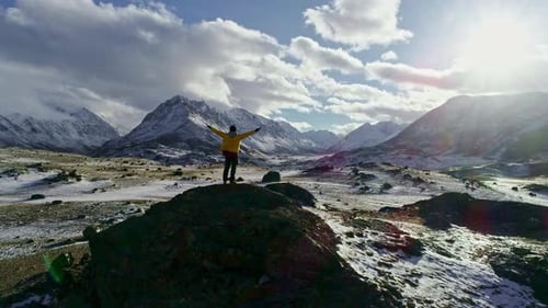 Man Standing On Rock Peak Snowy Winter Mountain Range Achievement Success Outstretched Arms