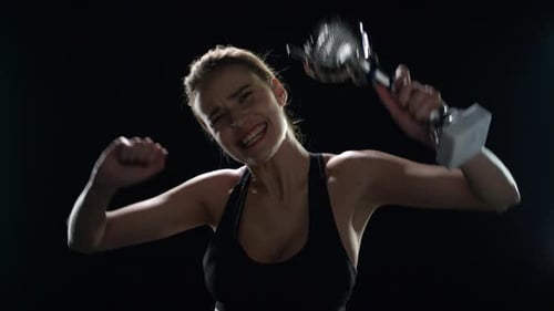 Woman Celebrates Sports Victory Holding Trophy