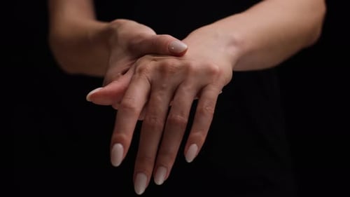 Woman Massaging Wrist for Health and Beauty