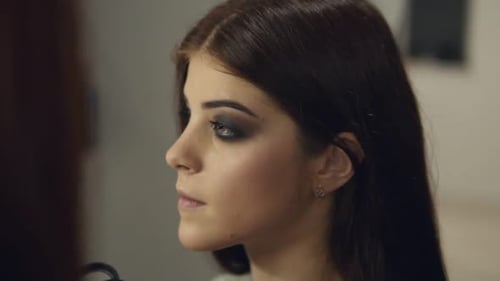 Makeup Artist Applying Eye Shadow Makeup to Model's Eye