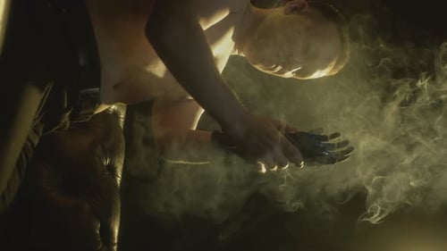 Shirtless Man Wearing Futuristic Robotic Arm Device