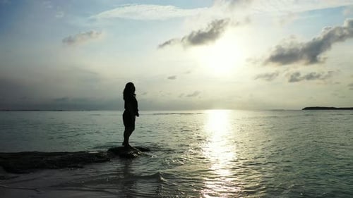 Young Happy Lady Traveling Having Fun on The Beach on Clean White Sand and Blue