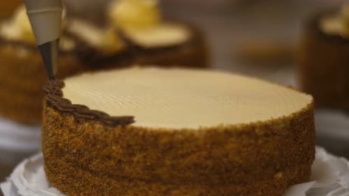 Close-up of Woman Hands Preparing a Cake