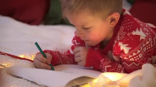 Young Boy Writing Letter at Christmas