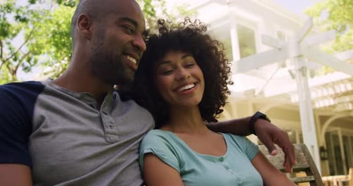 Happy mixed race couple enjoying in the garden during a sunny day