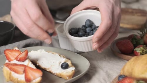 Preparing Toast with Berries for Breakfast at Home