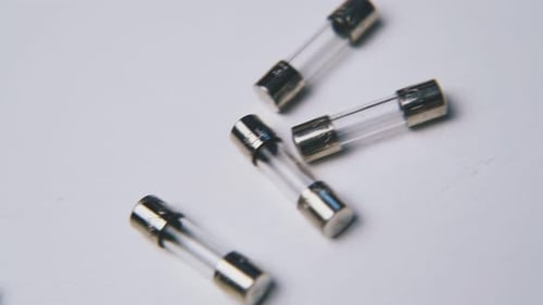 Close-Up of Glass Fuses on a White Surface