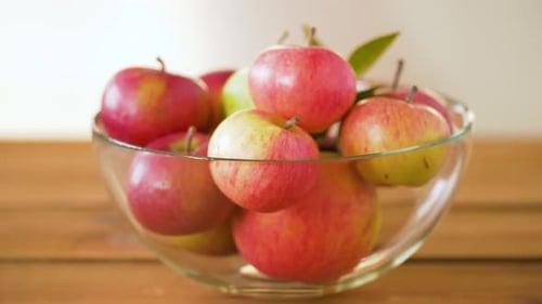 Ripe Apples in Glass Bowl on Wooden Table