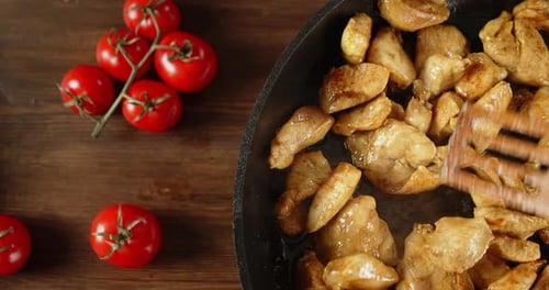 Chicken Being Cooked in Pan with Tomatoes