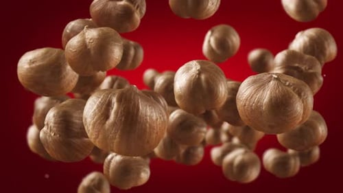 Hazelnuts Floating on a Red Background