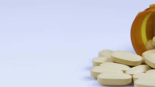 Pills Spilling From Prescription Bottle Close Up