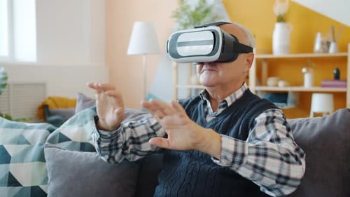 Senior Man Experiences Virtual Reality at Home