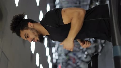 Fitness Man Training Cardio Exercise on Running Machine in Gym