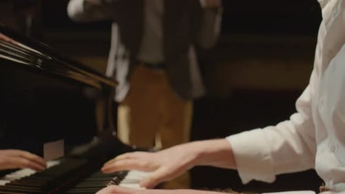 Pianist Performing with Violinist in Concert Hall