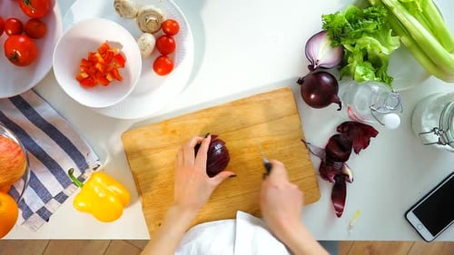Top View of a Young Woman of Finely Cut Red Onions.