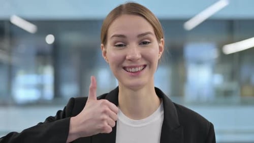 Businesswoman Smiling and Giving Thumbs Up