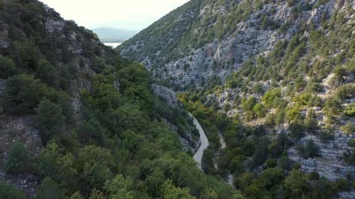 Aerial shot of an amazing green valley in between huge mountains
