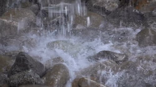 Water Flows Over Rocks in Nature Close Up