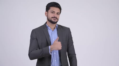 Young Happy Bearded Indian Businessman Giving Thumbs Up