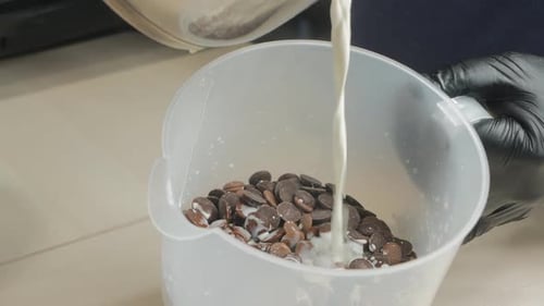 Cream Poured Over Chocolate Chips in White Bowl