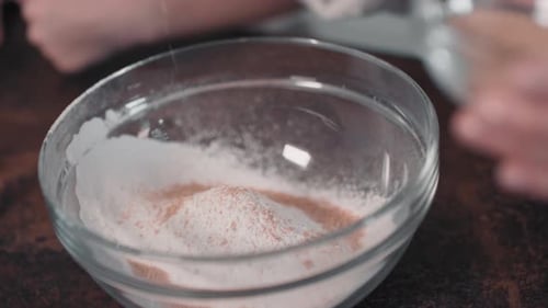 Ingredients Added to Flour in a Glass Bowl