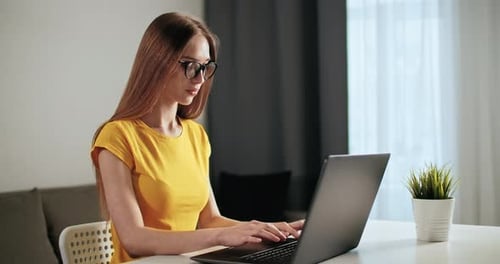Woman Works on Laptop
