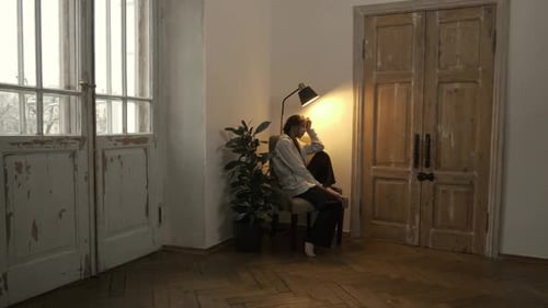 Young Adult Relaxing Indoors in Chair