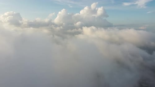 Aerial fly toward morning low cloud