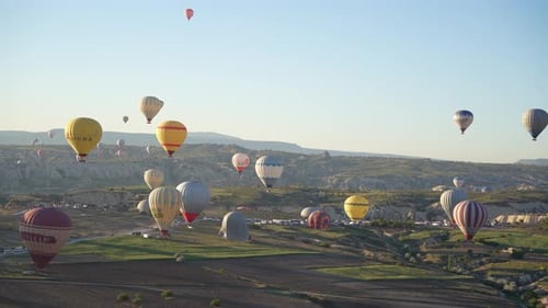 4K Aerial view of Goreme. Colorful hot air balloons fly over the valleys.