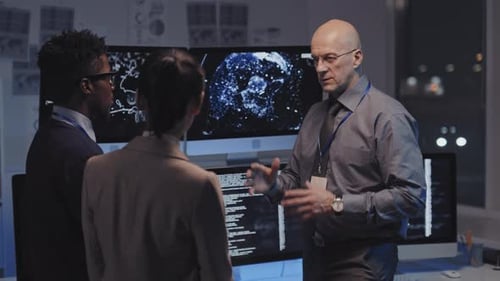 Colleagues Discussing Data Analysis in a Tech Office