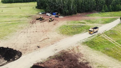 Aerial View of Big Yellow Truck That Carries Asphalt for Laying Road