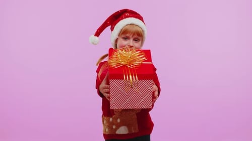 Girl with Gift Wearing a Santa Hat
