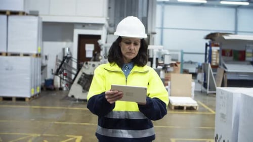 Woman Using Tablet in Manufacturing Plant
