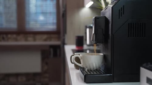 Coffee Machine Dispensing Coffee into Mug in Kitchen