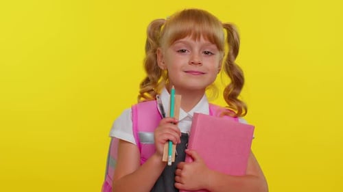 Smiling Girl Ready for School on Yellow Background