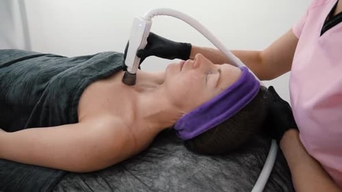 Woman Getting Beauty Treatment in Brightly Lit Room