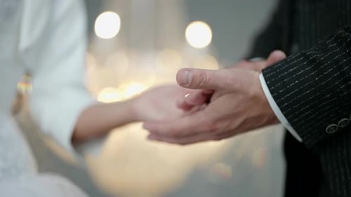 Hands of Newlyweds in Wedding Day Closeup View Man is Holding Palm of Young Bride