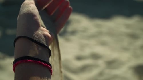 Sand Dropped From A Hand In Slowmotion