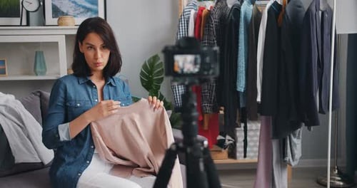 Young Woman Reviews Fashion in Vlogging Video