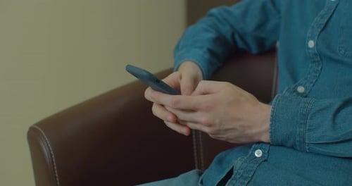 Person using smartphone indoors close up shot