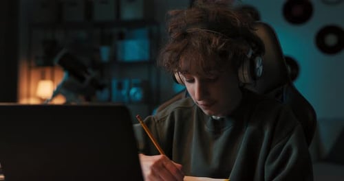 Student Studies at Desk with Laptop Late Night